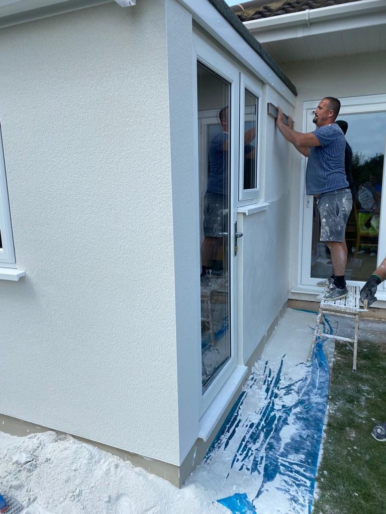 A&N Building renderer floating the top coat onto an external wall